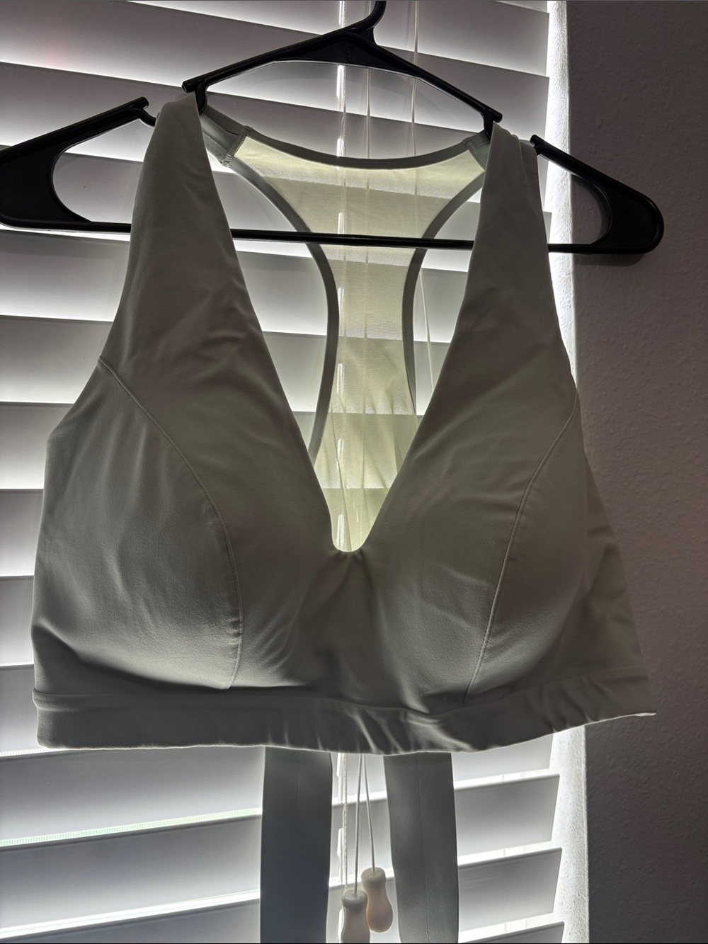 Women’s White Racerback sports bra. Straps cross under bra